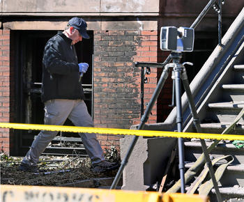 Boston Police Department investigator walks through crime scene
