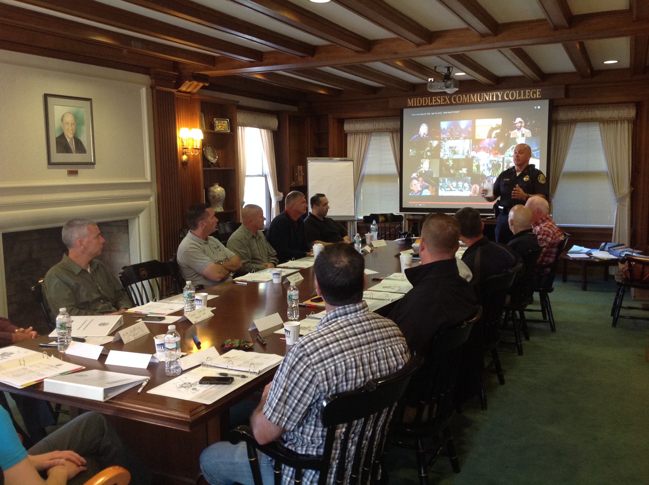 Lowell Police Department members attend a meeting around a table