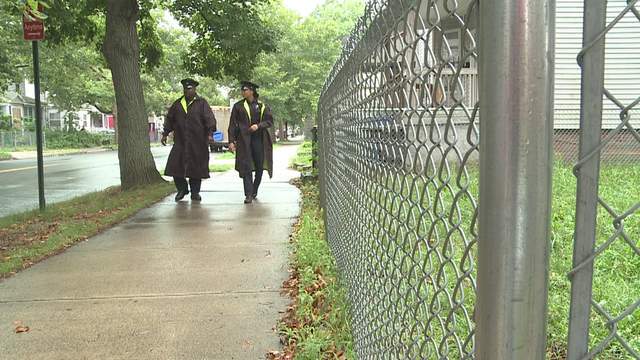 Two New Haven officers walk down the road