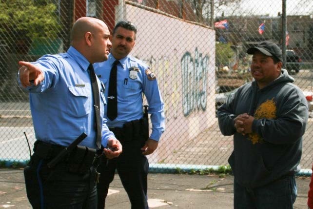 Philadelphia Police officers talk to community member