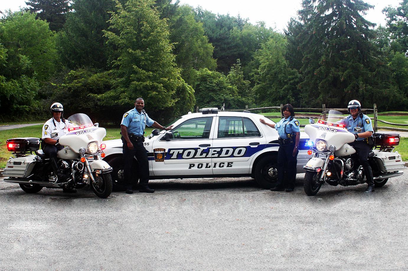 Toledo Police Department officers with vehicles