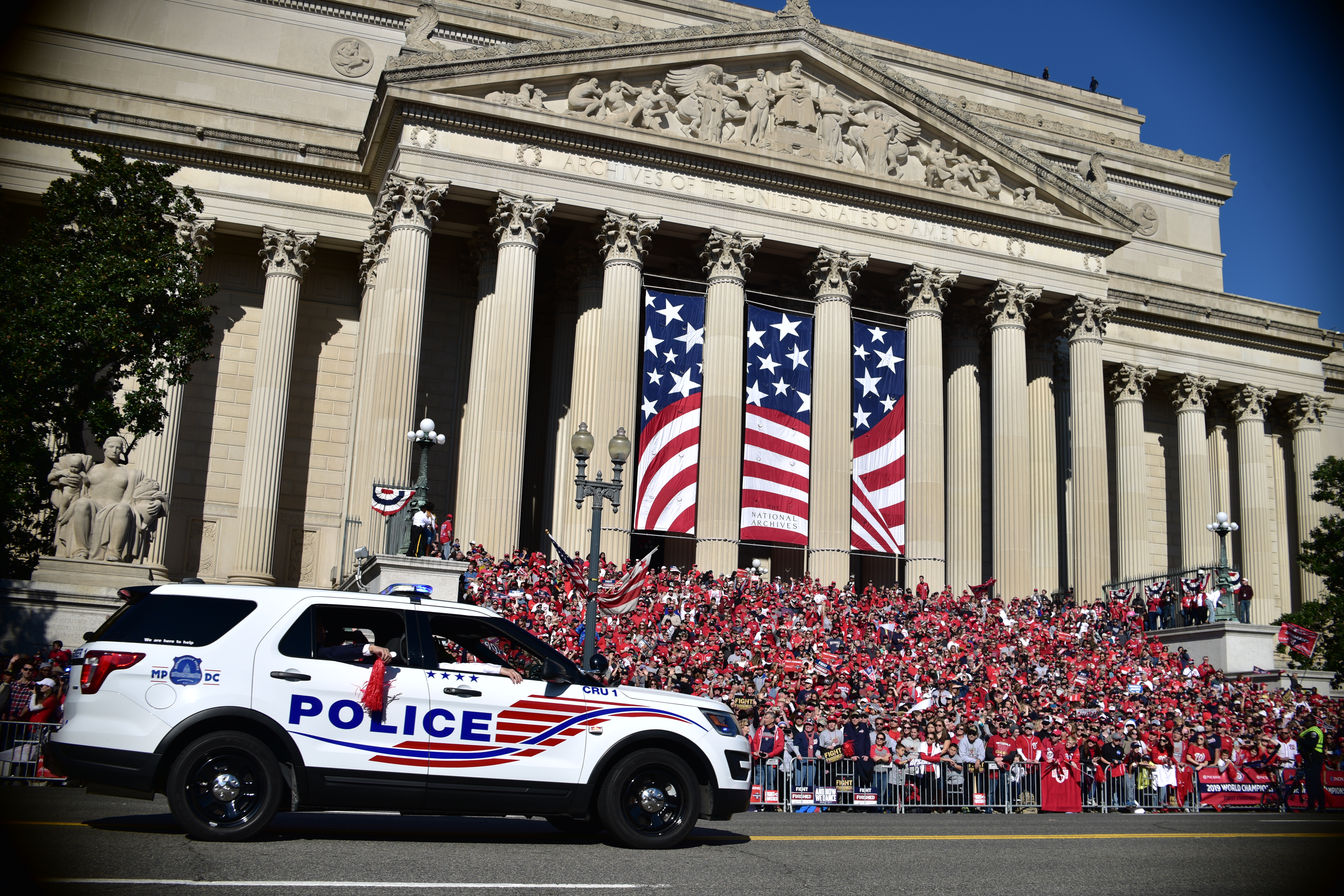 Metropolitan PD vehicle driving down street in front of museum